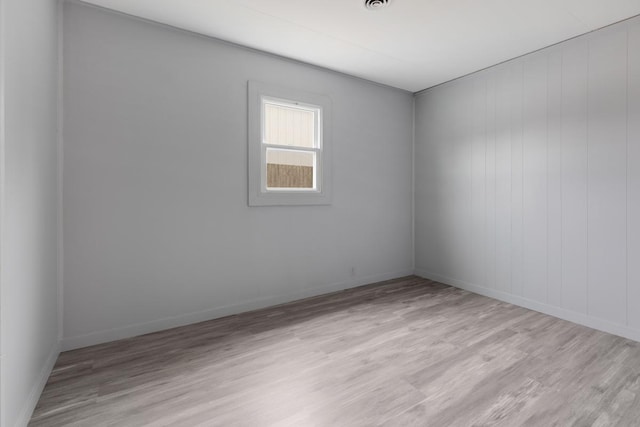unfurnished room featuring light wood-style flooring and baseboards