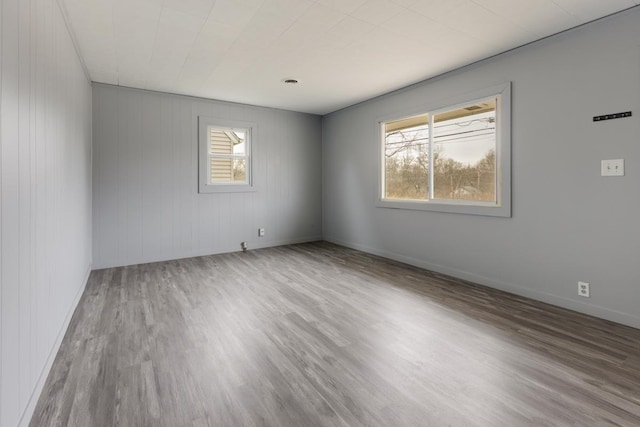 empty room featuring wood finished floors and baseboards