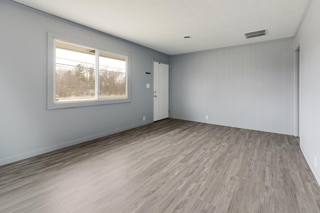 empty room featuring light wood-style flooring and baseboards