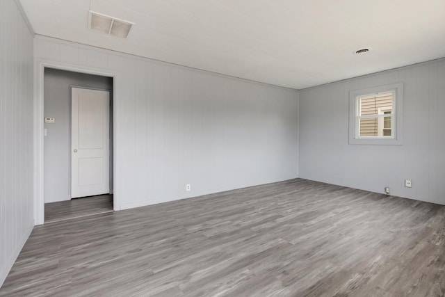 unfurnished room with wood finished floors