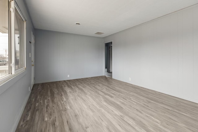 unfurnished room with light wood-type flooring