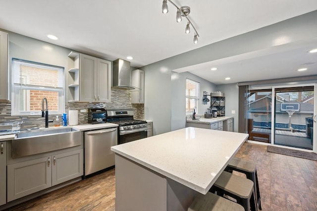 6522 S Kostner Ave, Chicago, IL 60629 - kitchen featuring wall chimney exhaust hood, appliances with stainless steel finishes, gray cabinetry, and a sink