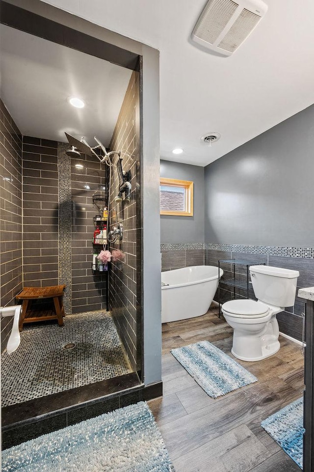 6522 S Kostner Ave, Chicago, IL 60629 - full bath featuring a soaking tub, toilet, tile walls, tiled shower, and visible vents