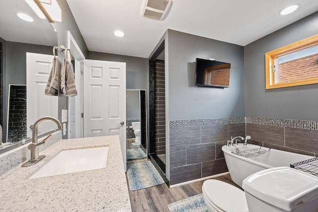 6522 S Kostner Ave, Chicago, IL 60629 - full bath with toilet, tile walls, visible vents, wood finished floors, and a shower stall