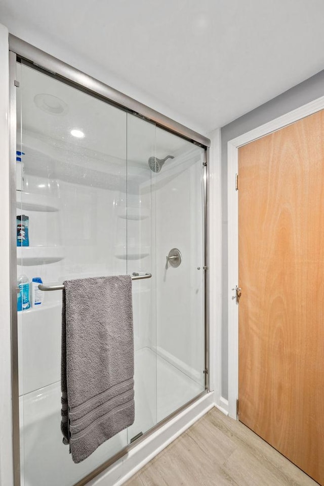 6522 S Kostner Ave, Chicago, IL 60629 - bathroom featuring wood finished floors and a stall shower