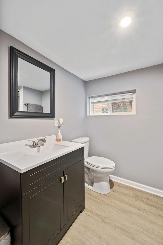 6522 S Kostner Ave, Chicago, IL 60629 - bathroom with toilet, vanity, wood finished floors, and baseboards