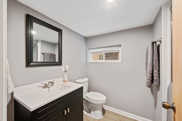 6522 S Kostner Ave, Chicago, IL 60629 - bathroom with baseboards, wood finished floors, toilet, and vanity