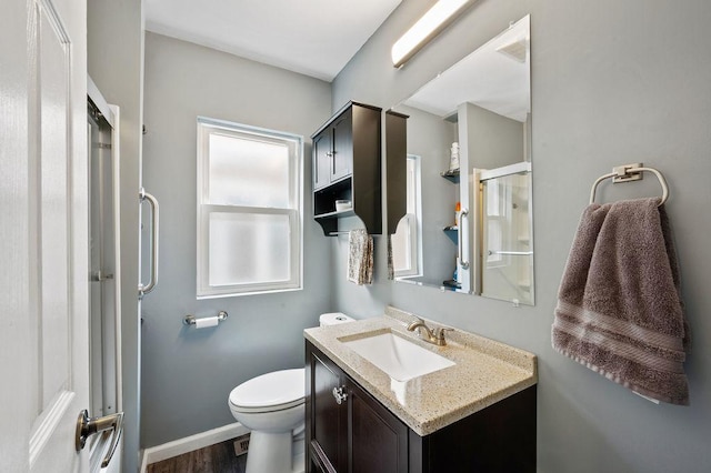 6522 S Kostner Ave, Chicago, IL 60629 - bathroom featuring wood finished floors, vanity, a shower stall, and toilet