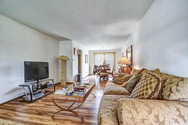 living area with baseboards and wood finished floors