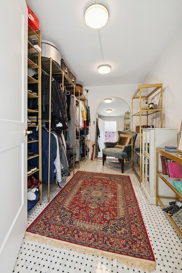 walk in closet with arched walkways