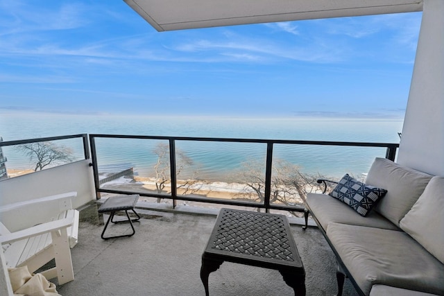 balcony featuring an outdoor living space, a view of the beach, and a water view
