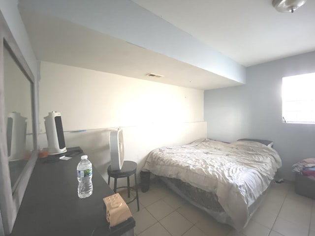 bedroom with tile patterned flooring and visible vents
