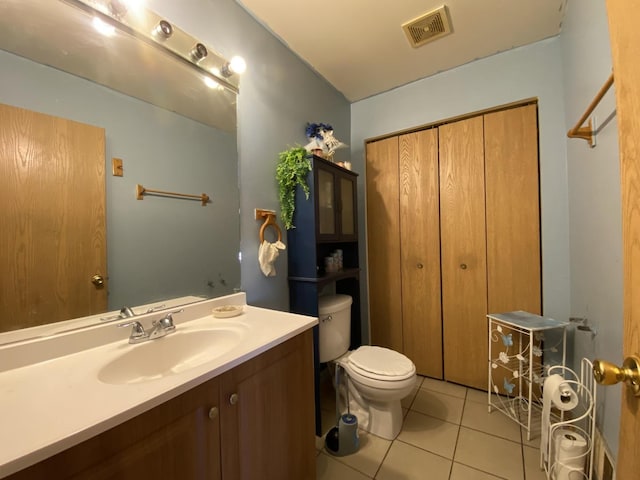 bathroom featuring visible vents, toilet, tile patterned flooring, and vanity