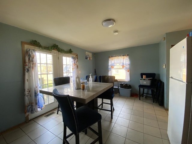 dining area with light tile patterned flooring