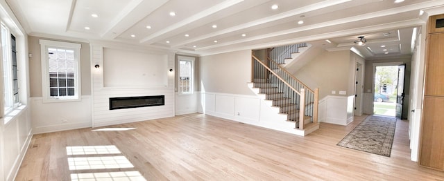 1911 S Prospect Ave, Park Ridge, IL 60068 - unfurnished living room with a glass covered fireplace, a decorative wall, light wood-type flooring, and stairway