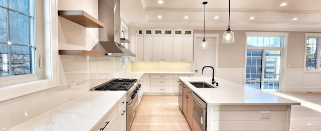1911 S Prospect Ave, Park Ridge, IL 60068 - kitchen featuring a kitchen island with sink, appliances with stainless steel finishes, light wood finished floors, range hood, and a sink