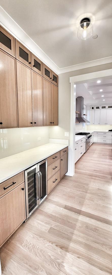 1911 S Prospect Ave, Park Ridge, IL 60068 - interior space featuring stainless steel stove, light wood-style flooring, and wine cooler