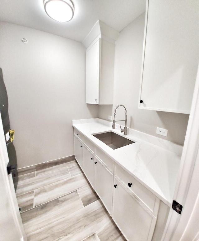 1911 S Prospect Ave, Park Ridge, IL 60068 - laundry area featuring baseboards, a sink, and light wood-type flooring