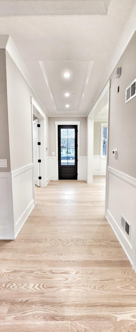 1911 S Prospect Ave, Park Ridge, IL 60068 - hall featuring visible vents, a decorative wall, and light wood-style flooring