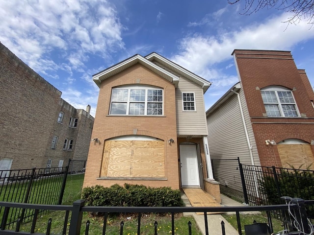 view of front of house featuring fence private yard and brick siding