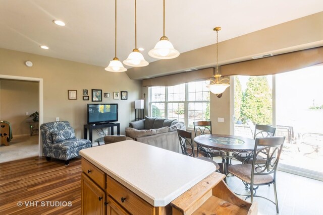 13474 Lehigh St, Huntley, IL 60142 - kitchen featuring dark wood-style flooring, brown cabinets, open floor plan, and pendant lighting