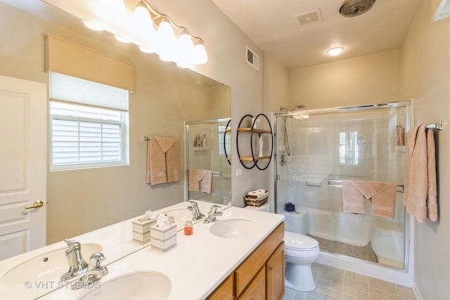 13474 Lehigh St, Huntley, IL 60142 - full bath featuring a sink, toilet, visible vents, and a shower stall
