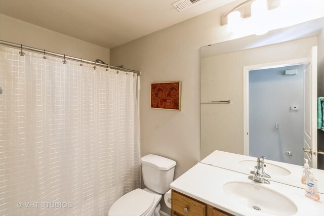 13474 Lehigh St, Huntley, IL 60142 - bathroom featuring toilet, visible vents, vanity, and a shower with shower curtain