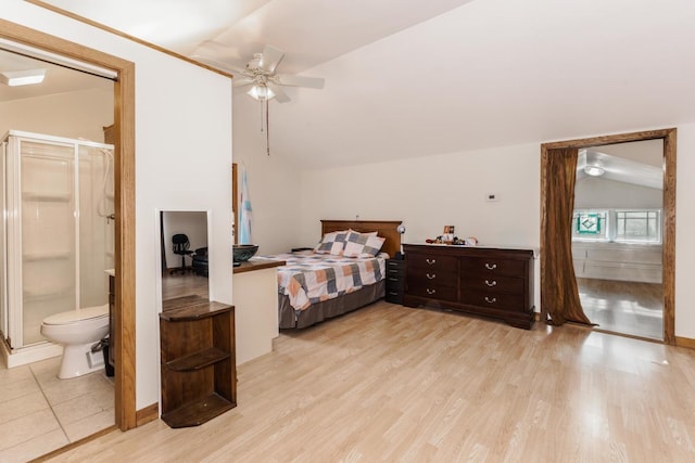 bedroom with lofted ceiling, light wood-style floors, ceiling fan, and connected bathroom