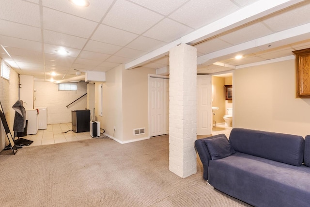 below grade area with light carpet, washer / dryer, recessed lighting, and baseboards
