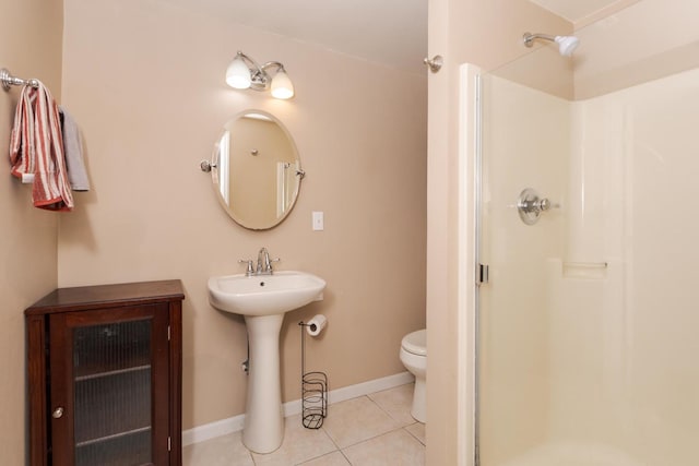 full bathroom featuring a shower stall, tile patterned flooring, and toilet