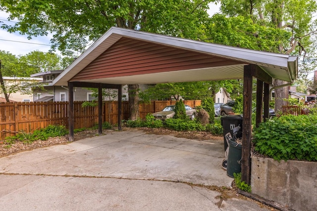 view of parking featuring a carport and fence
