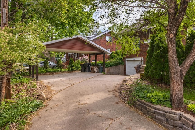 view of front of property with concrete driveway, brick siding, and a garage