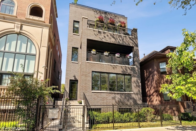 1516 W Wrightwood Ave Unit 3, Chicago, IL 60614 - view of front of property featuring brick siding, a balcony, and a fenced front yard