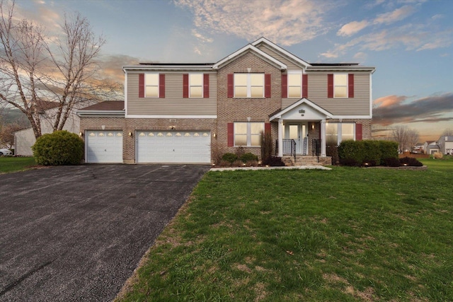 229 Stone Hollow Dr, Poplar Grove, IL 61065 - traditional home featuring brick siding, solar panels, driveway, and a yard