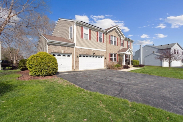 229 Stone Hollow Dr, Poplar Grove, IL 61065 - view of front of house with brick siding, an attached garage, driveway, and a front lawn