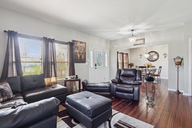 229 Stone Hollow Dr, Poplar Grove, IL 61065 - living room featuring baseboards, a notable chandelier, and dark wood-style flooring