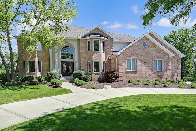 909 Prairie Ridge Ct, Burr Ridge, IL 60527 - traditional-style home with french doors, a front yard, brick siding, and roof with shingles
