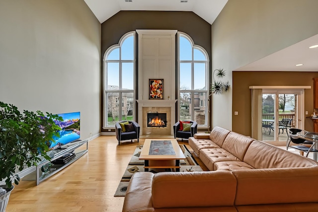 909 Prairie Ridge Ct, Burr Ridge, IL 60527 - living room with wood finished floors, plenty of natural light, a glass covered fireplace, high vaulted ceiling, and recessed lighting