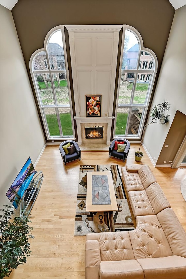 909 Prairie Ridge Ct, Burr Ridge, IL 60527 - living room with light wood finished floors, baseboards, and a fireplace