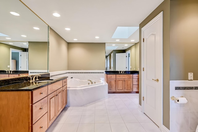909 Prairie Ridge Ct, Burr Ridge, IL 60527 - bathroom featuring a skylight, a garden tub, two vanities, tile patterned floors, and recessed lighting