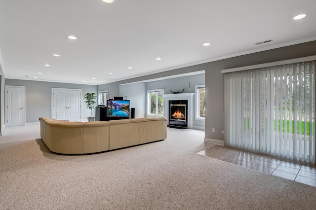 909 Prairie Ridge Ct, Burr Ridge, IL 60527 - tiled living area featuring carpet, recessed lighting, ornamental molding, a glass covered fireplace, and baseboards