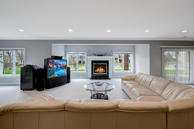 909 Prairie Ridge Ct, Burr Ridge, IL 60527 - living area with ornamental molding, healthy amount of natural light, a tiled fireplace, carpet floors, and recessed lighting