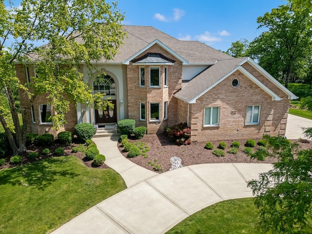 909 Prairie Ridge Ct, Burr Ridge, IL 60527 - traditional home with a front lawn, brick siding, and a shingled roof