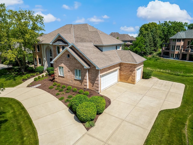 909 Prairie Ridge Ct, Burr Ridge, IL 60527 - view of front of house with an attached garage, driveway, brick siding, a front yard, and roof with shingles