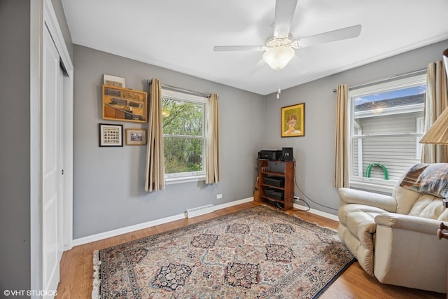 sitting room featuring wood finished floors, visible vents, a ceiling fan, and baseboards