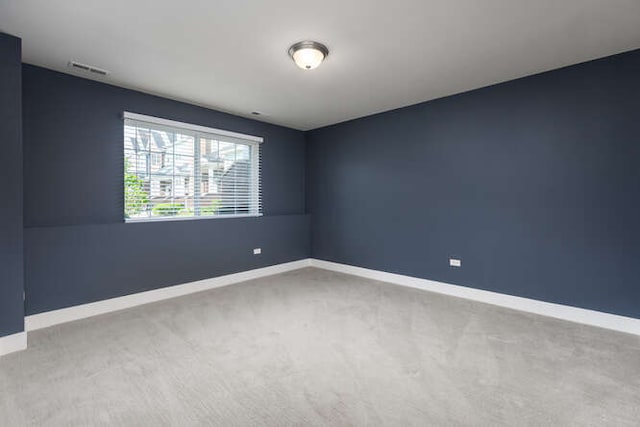 carpeted empty room with baseboards