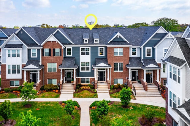 multi unit property featuring a residential view and brick siding