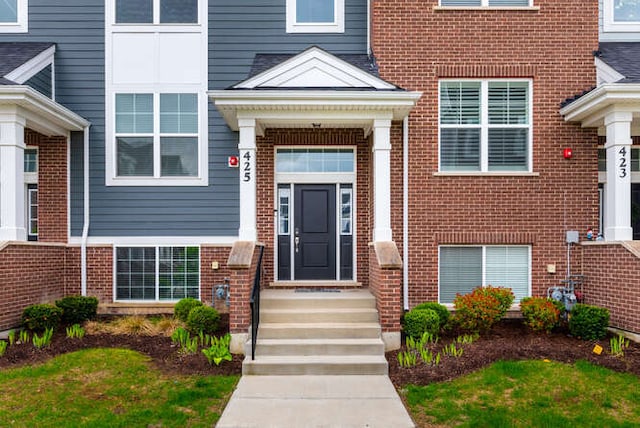 entrance to property with brick siding