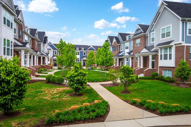 view of property's community with a residential view and a yard