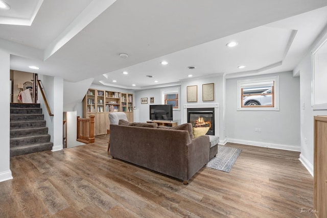 living area featuring recessed lighting, wood finished floors, stairs, and baseboards